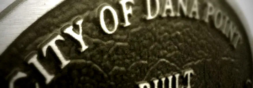 Close-up of the raised lettering on a City of Dana Point historic plaque